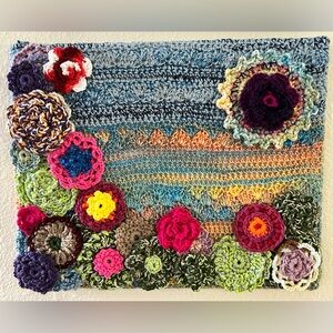 Colorful Crochet Wall Hanging with Floral Accents